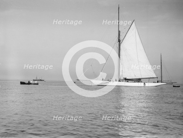 Sailing yacht 'Bona' being towed, 1912. Creator: Kirk & Sons of Cowes.