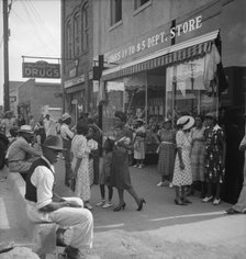 Saturday afternoon - shopping and visiting on main street of Pittsboro, North Carolina, 1939. Creator: Dorothea Lange.
