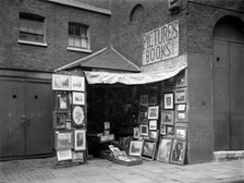 Framed pictures displayed outside a second hand book and picture shop, London, 1933.  Artist: WA Clark