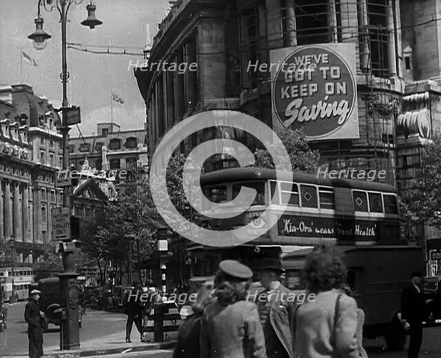 People and Traffic Moving Around a City, 1941. Creator: British Pathe Ltd.