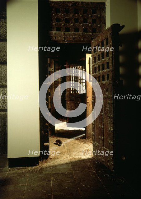 A reconstruction of a corridor in Newgate Gaol, with original doors. Artist: Unknown