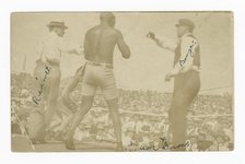 Photographic postcard of James J. Jeffries staggering away from Jack Johnson, 1910. Creator: Unknown.