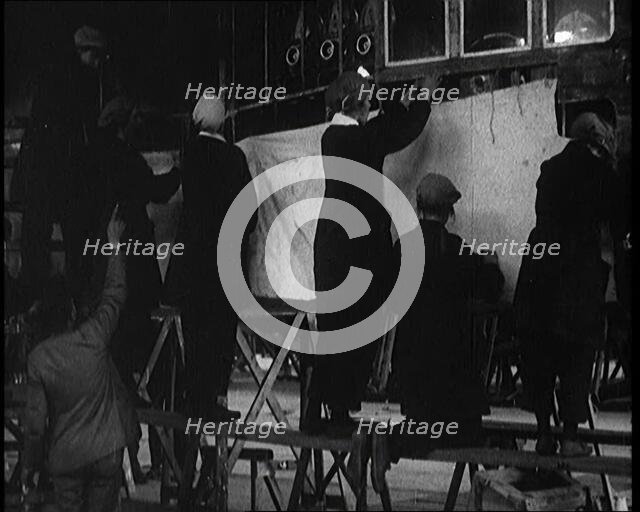 Men and Women Building the Body of the Cockpit of an R 38 Airship in a Hangar, 1921. Creator: British Pathe Ltd.