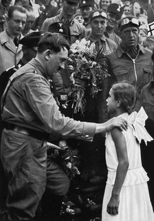 Adolf Hitler talking with a young girl during his election campaign, 1932. Artist: Unknown