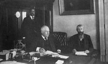 Three men in office in Bureau of Engraving and Printing, Washington, D.C., 1889 or 1890. Creator: Frances Benjamin Johnston.