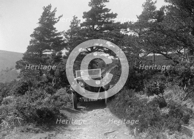 Kitty Brunell road testing a Riley 9 WD tourer, c1930. Artist: Bill Brunell.