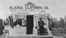 Man in front of Alaska Clothing Co. store, between c1900 and 1916. Creator: Unknown.