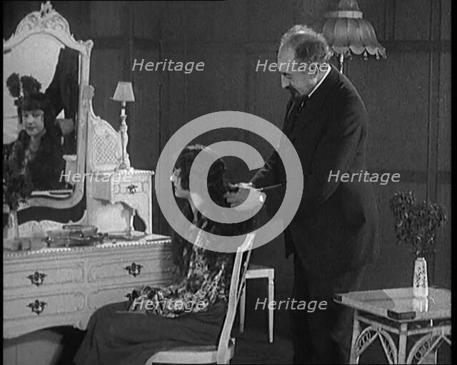 Female Civilian Having Her Hair Cut Into a 'Shingle' by a Male Civilian Hairdresser, 1920. Creator: British Pathe Ltd.
