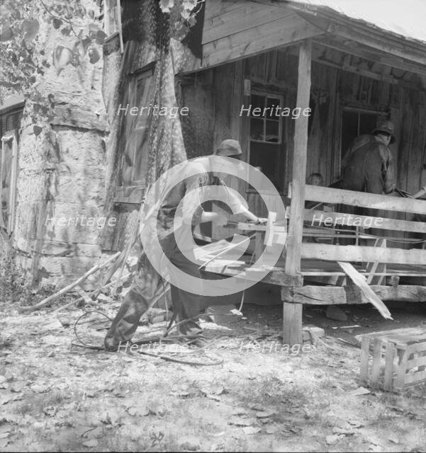 In Arkansas Hills (Ozarks) near Seligman, Missouri, splitting hickory for chair-bottoms, 1938. Creator: Dorothea Lange.