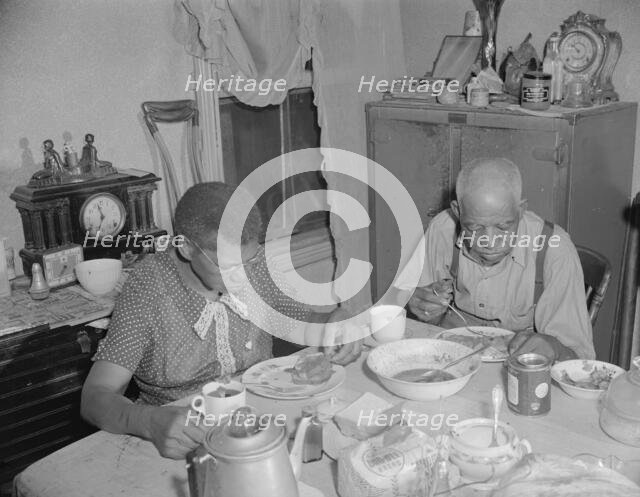 Elderly couple eating dinner at their home on Lamont Street, N.W., Washington, D.C., 1942. Creator: Gordon Parks.