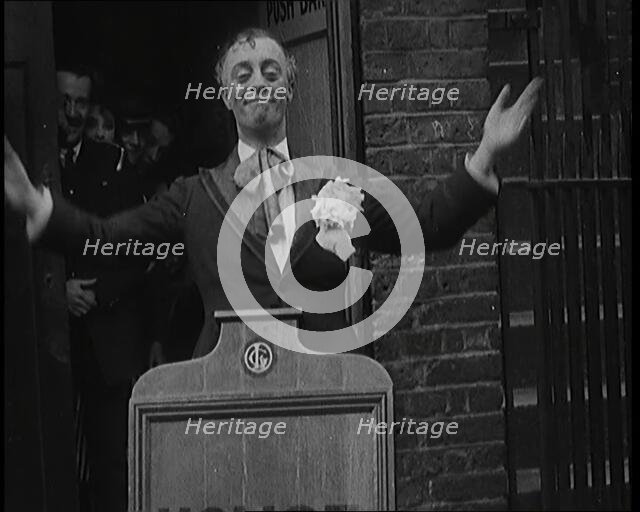 The Actor Leslie Henson Rising Spookily up from Behind a Mock Gravestone, 1920s. Creator: British Pathe Ltd.