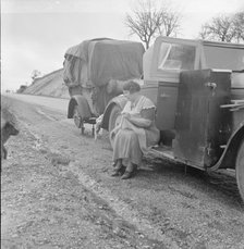 Migrant pea workers on the road, all their worldly possessions in car and trailer, California, 1936. Creator: Dorothea Lange.