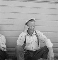 Bindle stiff, used to be logger, Side of Pastime Café, Tulelake, Siskiyou County, California, 1939. Creator: Dorothea Lange.
