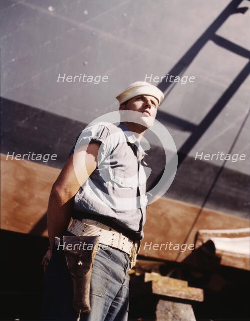 Coast Guardsman standing watch over 78-foot torpedo..., Higgins Industries, Inc., New Orleans, 1942. Creator: Howard Hollem.