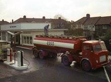 Ilford Esso petrol station with Leyland tanker making delivery 1964. Creator: Unknown.
