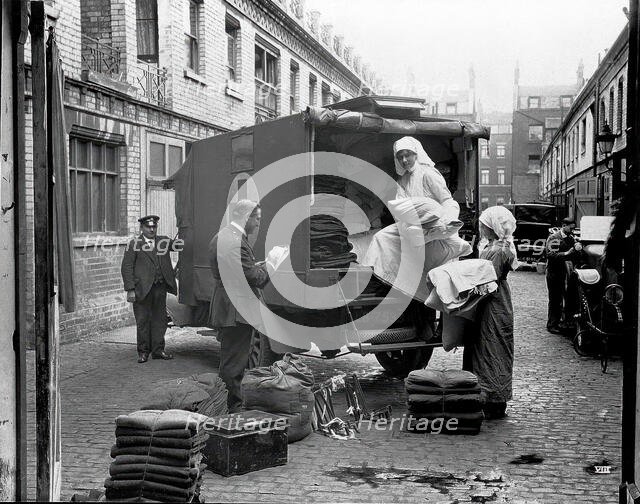 Ambulance Column depot, 9 Gower Street, London: loading up the blanket bus in Gower Mews, 1918. Creator: Unknown.