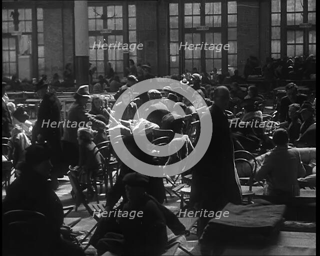 Dutch Refugees Sitting and Eating at a Reception Centre in the United Kingdom, 1940. Creator: British Pathe Ltd.
