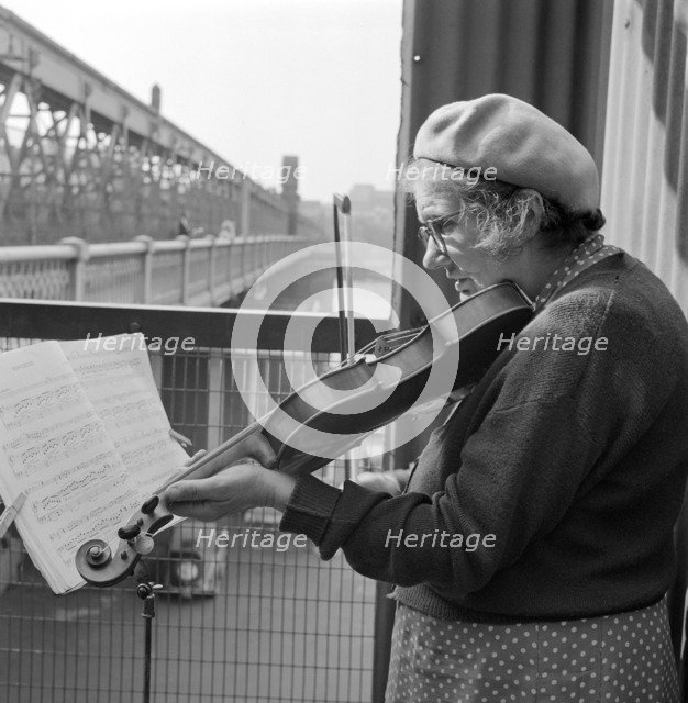 Busker playing the violin, Hungerford Bridge, Lambeth, London, c1946-c1959. Artist: John Gay