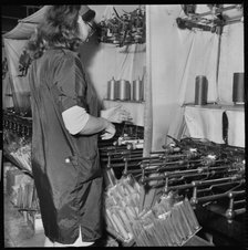Woman operating a cop winding frame in a textile mill, 1966-1974. Creator: Eileen Deste.