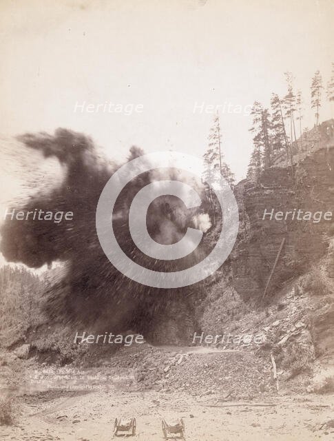 In mid air A wonderful blast in building railroad to Deadwood, 1890. Creator: John C. H. Grabill.