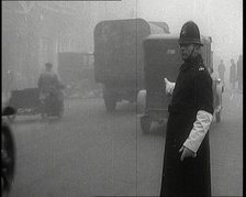 Male British Police Officer Controlling the Traffic On the Streets of London, 1920s. Creator: British Pathe Ltd.