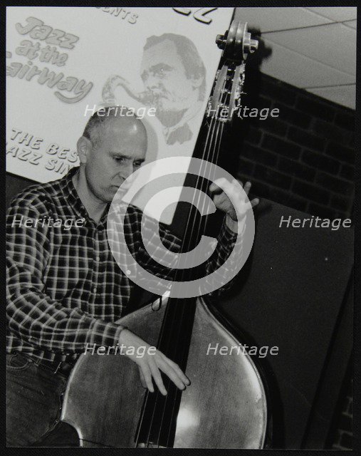 Bassist Simon Woolf playing at The Fairway, Welwyn Garden City, Hertfordshire, 2002. Artist: Denis Williams