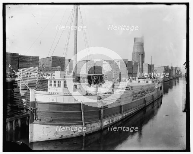 Loading lumber on steamer at lumberyards, Menominee, Mich., between 1880 and 1899. Creator: Unknown.