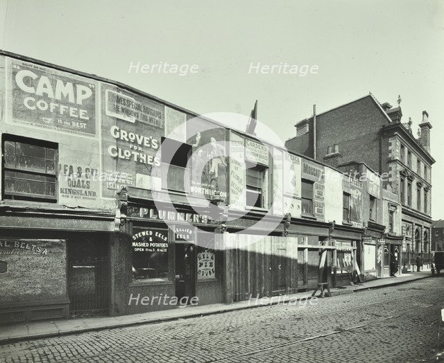 Row of shops with advertising hoardings, Balls Pond Road, Hackney, London, September 1913. Artist: Unknown.