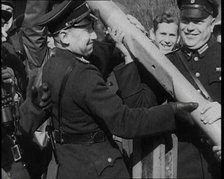 Male German Officers Removing a Barrier at a Checkpoint on the Border Between Germany and..., 1938. Creator: British Pathe Ltd.