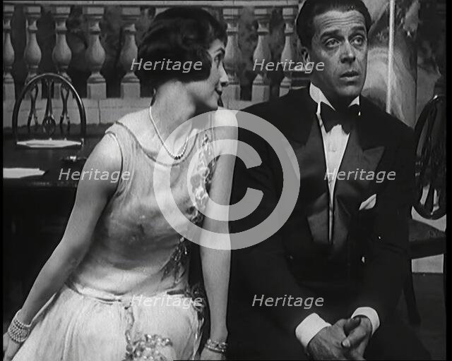 Jack Buchanan and June Knight Sitting on a Bench Together. Buchanan Looking Uncomfortable...,1920s Creator: British Pathe Ltd.