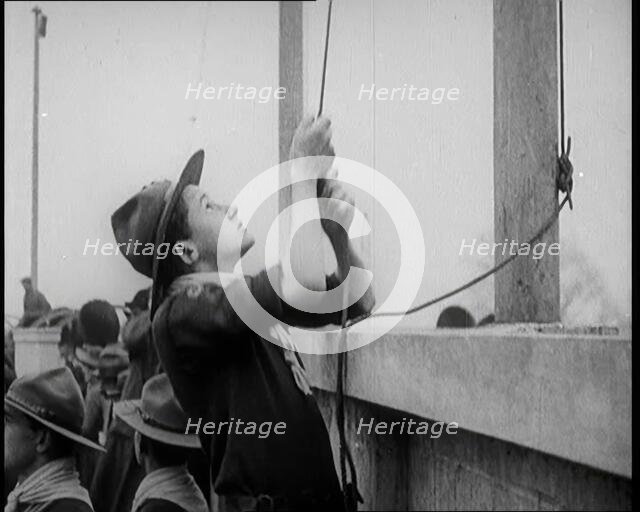 Male Boy Scout Unfurls the Flags of the British Empire, 1924. Creator: British Pathe Ltd.