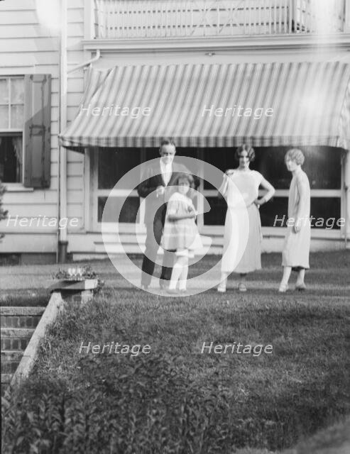 Dunning family, standing outside house, 1925 July 9. Creator: Arnold Genthe.