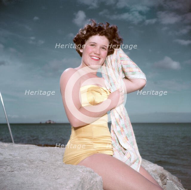Portrait of a young woman in a swimsuit by the sea, c1955. Creator: Arthur Charles Kirby Ware.