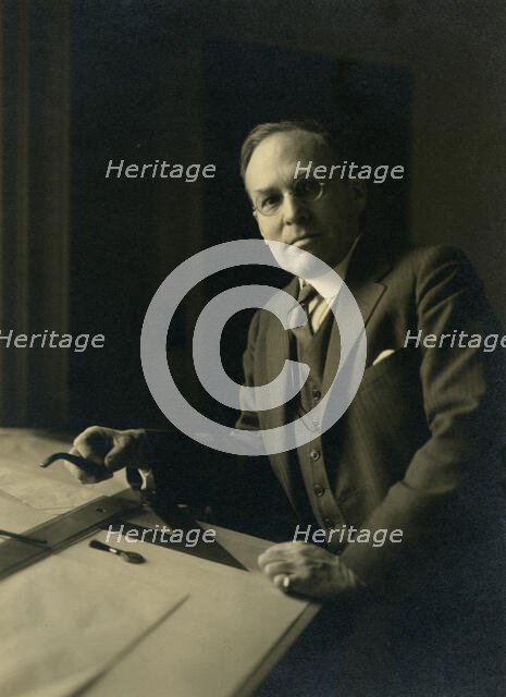Leicester B. Holland, Chief of Fine Arts Division, Library of Congress posed...table, (1930?). Creator: Frances Benjamin Johnston.