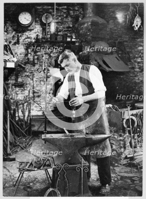 Mr Jefferies at work in the forge, Southrop, Cotswolds, Gloucestershire, 1938. Creator: Sydney Alfred Pitcher.