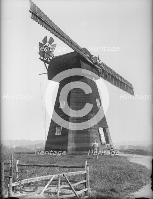 Exterior of the Old Mill, Northbourne, Kent with the miller, Mr J Court, stood outside, 1933. Creator: HES Simmons.