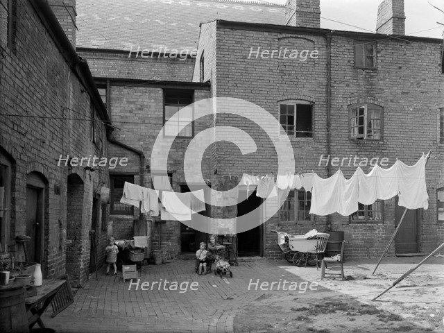 Children in a run-down courtyard, Warwickshire, 1946. Artist: Unknown