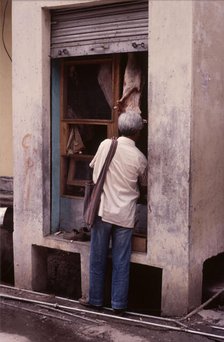 Tiny butcher's shop, McLeod Ganj, Dharamsala, India, 1988.  Creator: Amanda Waite.