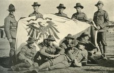 New Zealand soldiers with captured German flag, First World War, 1914, (c1920). Creator: Unknown.