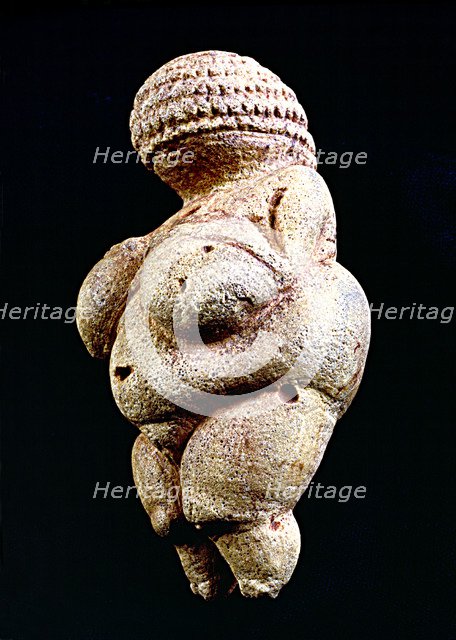 Venus of Willendorf', 110 mm.: woman statue made in limestone and painted with ochre. It is rhomb…