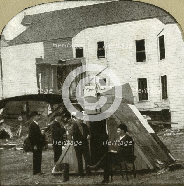 'Refugees' camp, former dwelling in ruins in background. This is earthquake work', 1906.  Creator: Unknown.