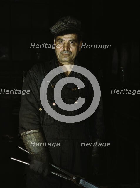 Daniel Anastazia, blacksmith's helper...roundhouse of the Rock Island R.R., Blue Island, Ill., 1943. Creator: Jack Delano.