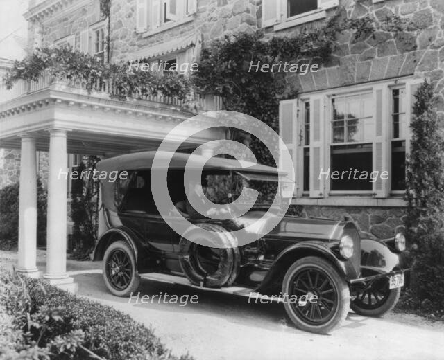 Automobile owned by Mrs. Charles W. Richardson in driveway with driver at the...Washington DC, c1919 Creator: Frances Benjamin Johnston.