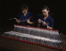 Capping and inspecting tubing: two women are shown...at Vultee's Nashville division, Tennessee, 1943 Creator: Alfred T Palmer.