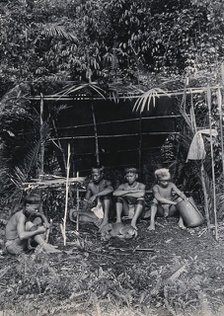 Sarawak: four Kayan hunters in their camp, c1900. Creator: Unknown.