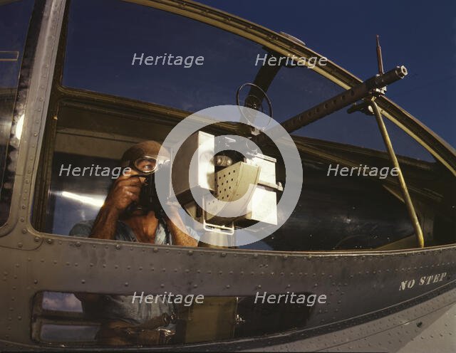 Jesse Rhodes Waller, A.O.M., third class, tries out a 30-calibre...Naval Air Base, Corpus..., 1942. Creator: Howard Hollem.