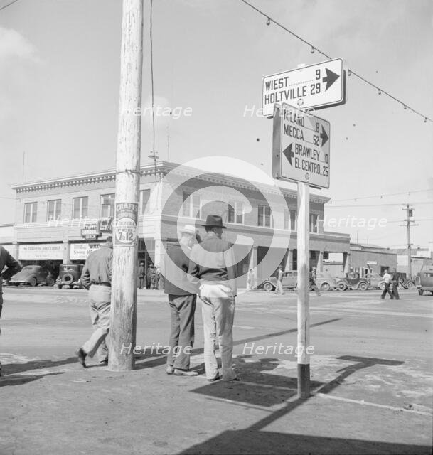 Idle pea pickers discuss prospects for work, Calipatria, Imperial Valley, California, 1939. Creator: Dorothea Lange.