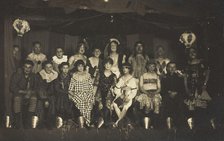 An ensemble cast of British soldiers, some in drag, pose on stage, 1919. Creator: Unknown.