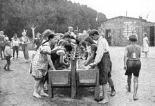 Washing-up at a juvenile summer holiday camp, Germany, 1922.Artist: Otto Haeckel