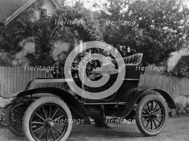 A baby on the seat of a De Dion Bouton car, 1903. Artist: Unknown
